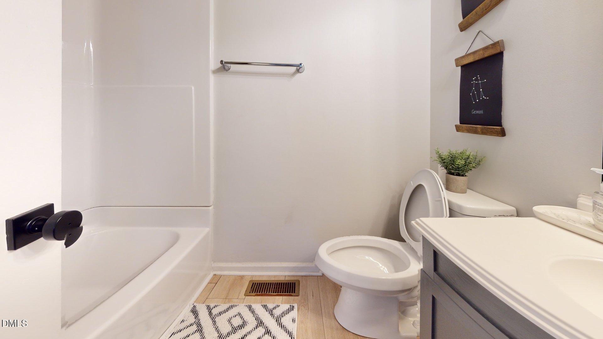 7720 Foxwood Drive Raleigh, NC 27615 - Photo 22 of 46 a white toilet sitting next to a bathroom sink and tub
