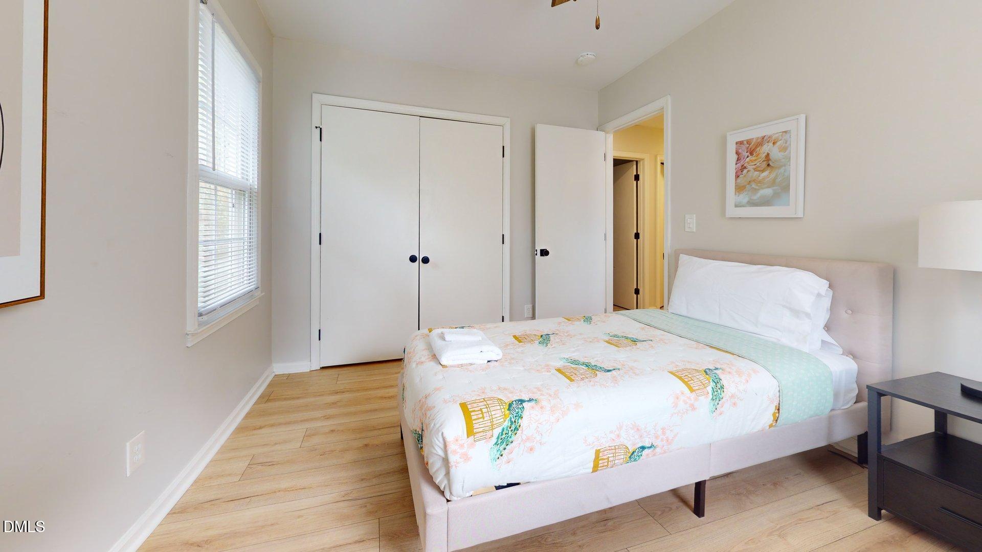 7720 Foxwood Drive Raleigh, NC 27615 - Photo 24 of 46 a bedroom with a bed and wooden floor