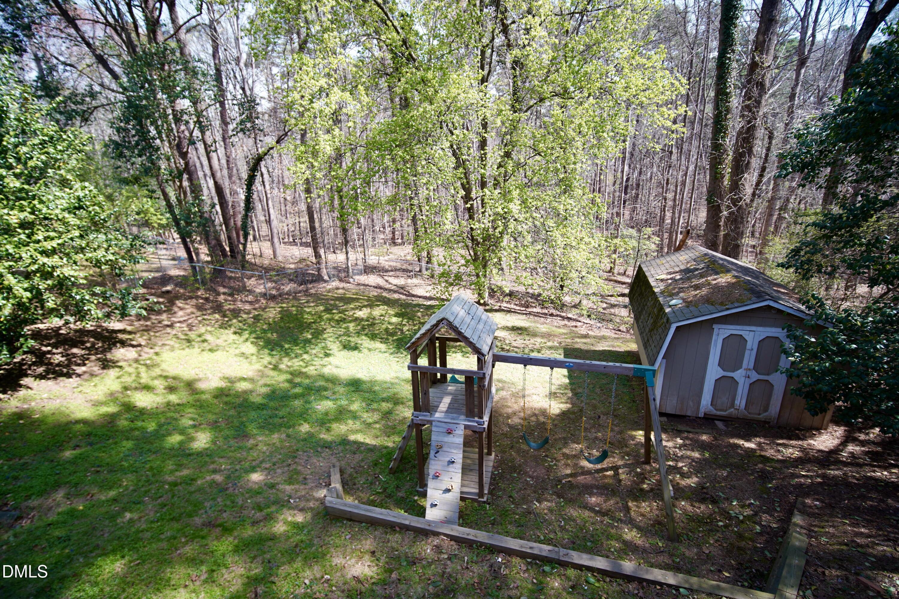 7720 Foxwood Drive Raleigh, NC 27615 - Photo 31 of 46 a view of a backyard with large trees
