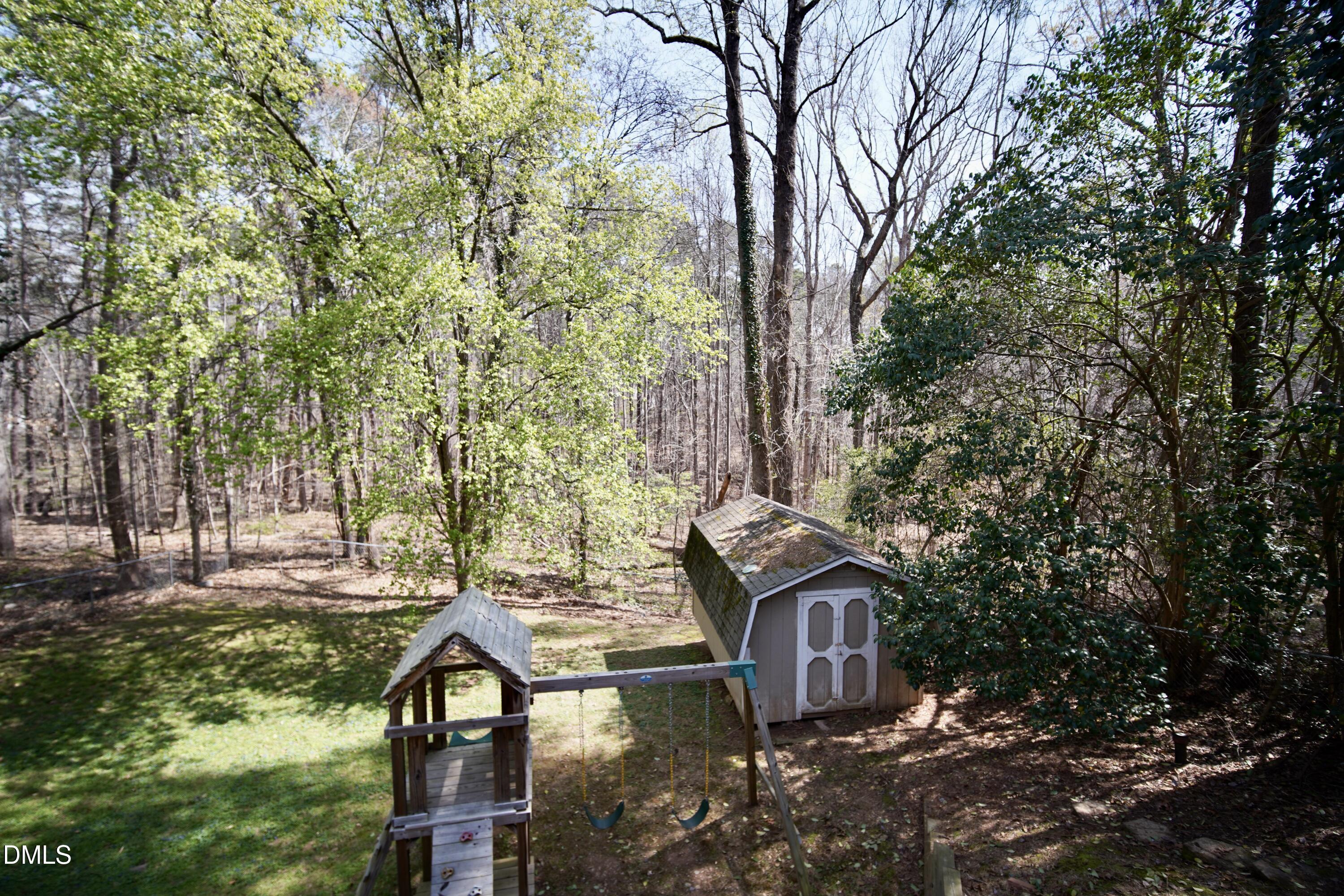 7720 Foxwood Drive Raleigh, NC 27615 - Photo 44 of 46 a view of house with backyard and trees