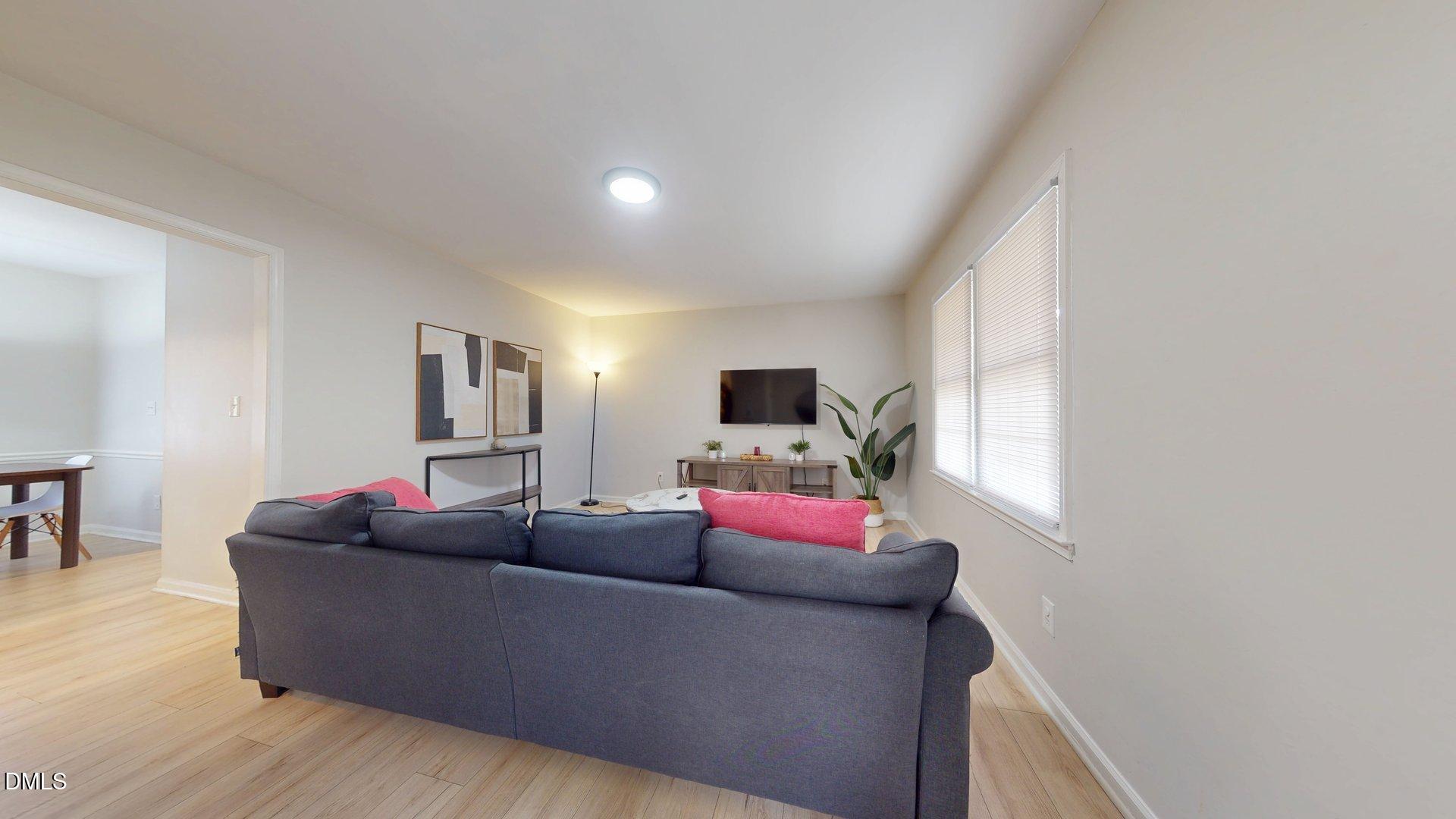 7720 Foxwood Drive Raleigh, NC 27615 - Photo 5 of 46 a living room with furniture a flat screen tv and a window