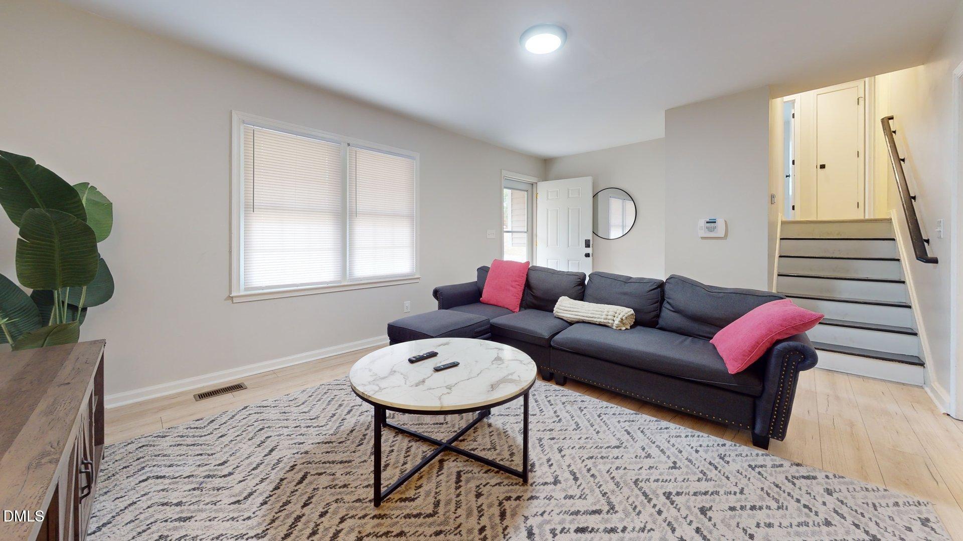 7720 Foxwood Drive Raleigh, NC 27615 - Photo 7 of 46 a living room with furniture and a window