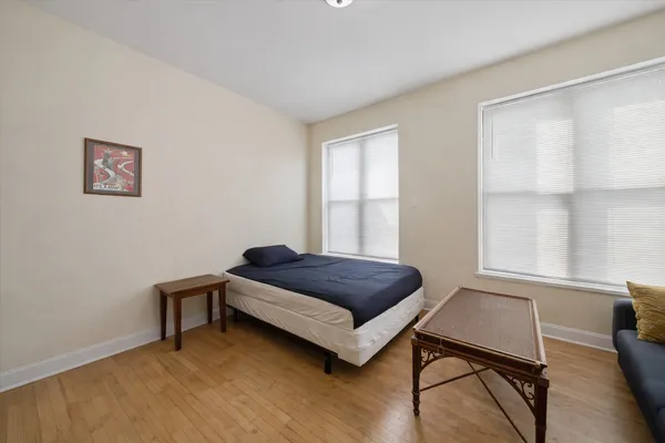 a living room with a bed furniture and a window