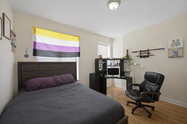 a bedroom with a bed and a chair