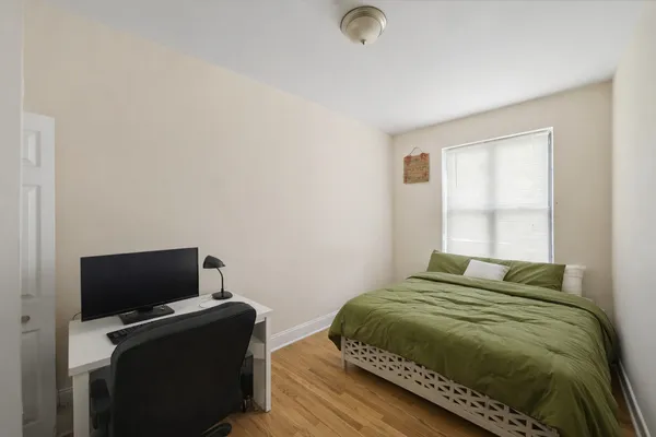 a bedroom with a bed and a television