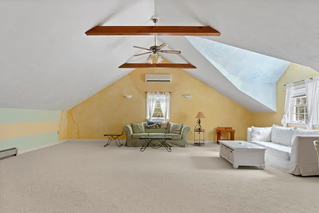 a bedroom with a bed couch and window