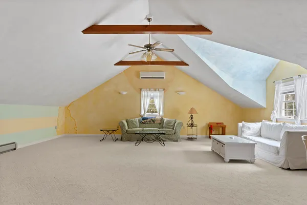 a bedroom with a bed couch and window