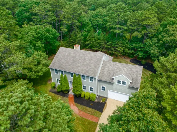 an aerial view of a house with yard and outdoor seating