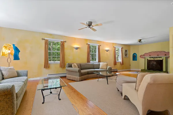 a living room with furniture a fireplace and a window