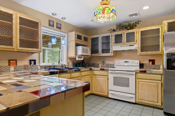 a kitchen that has a lot of cabinets in it and a window