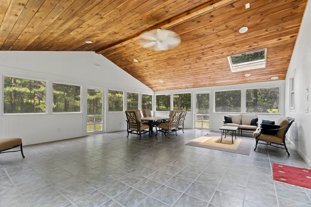 a living room with furniture and floor to ceiling window