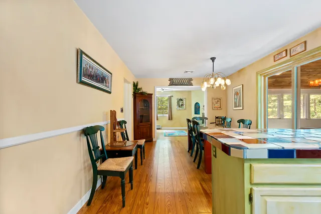 a view of a dining room with furniture and a chandelier