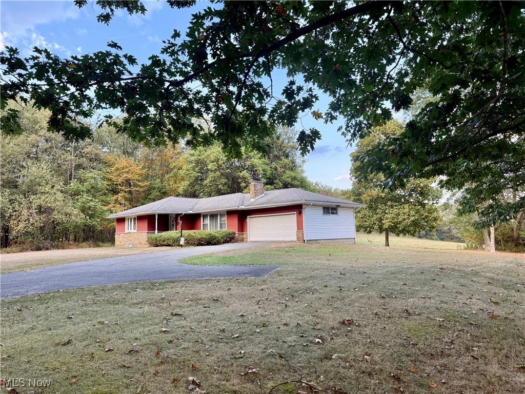 4878 Wylie Ridge Road New Cumberland, WV 26047 - Photo 15 of 20 Ranch-style home with a garage, a chimney, driveway, a front yard, and stone siding