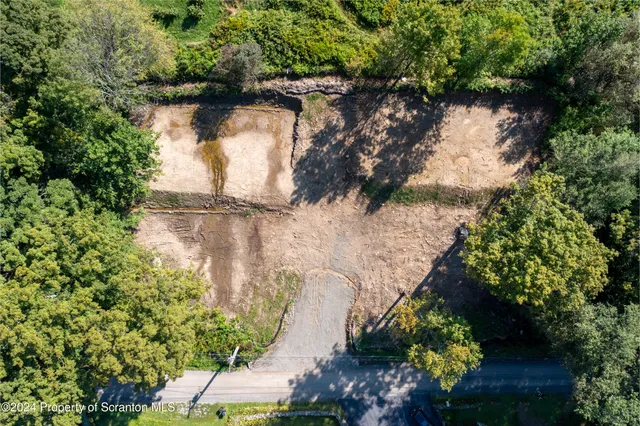 an aerial view of a house with a yard and lake view