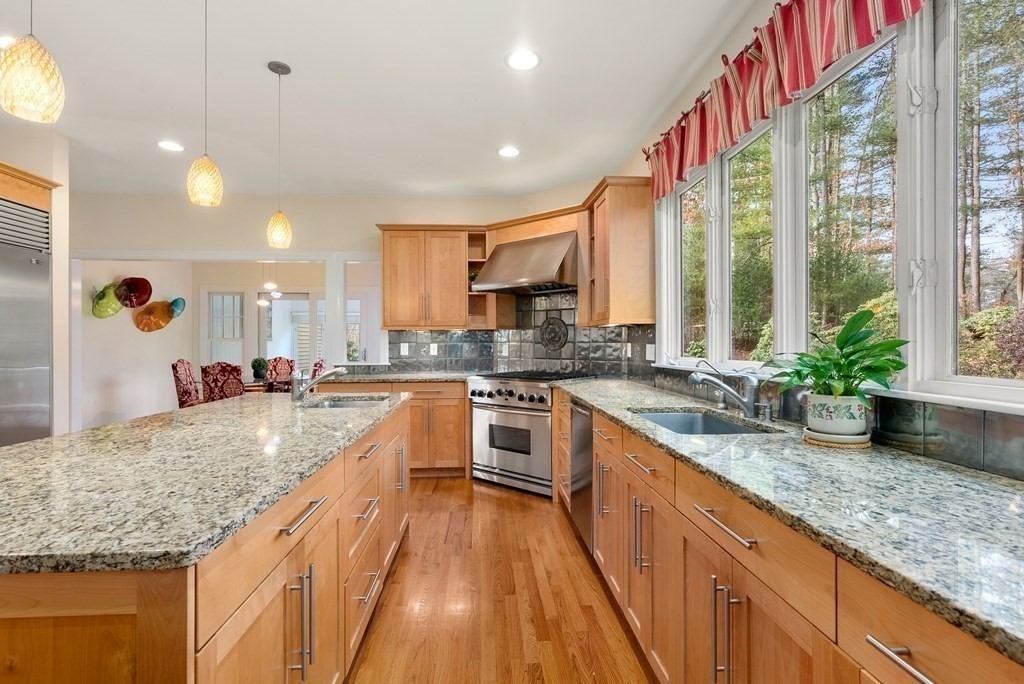 353 Dutton Road Sudbury, MA 01776 - Photo 11 of 42 a large kitchen with kitchen island granite countertop a large counter top
