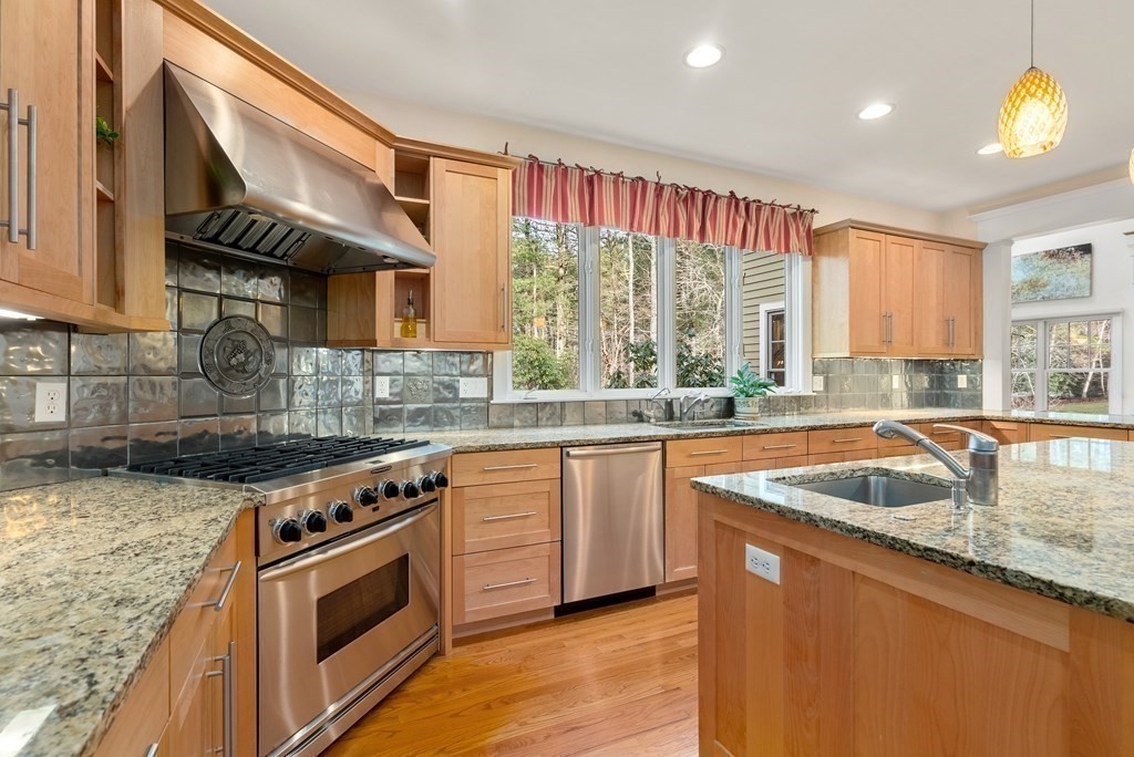 353 Dutton Road Sudbury, MA 01776 - Photo 13 of 42 a kitchen with stainless steel appliances granite countertop a sink a stove and a wooden cabinets