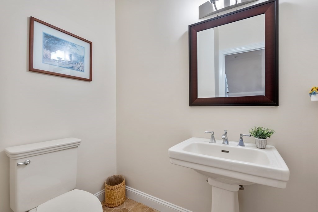 353 Dutton Road Sudbury, MA 01776 - Photo 19 of 42 a bathroom with a toilet a sink and mirror