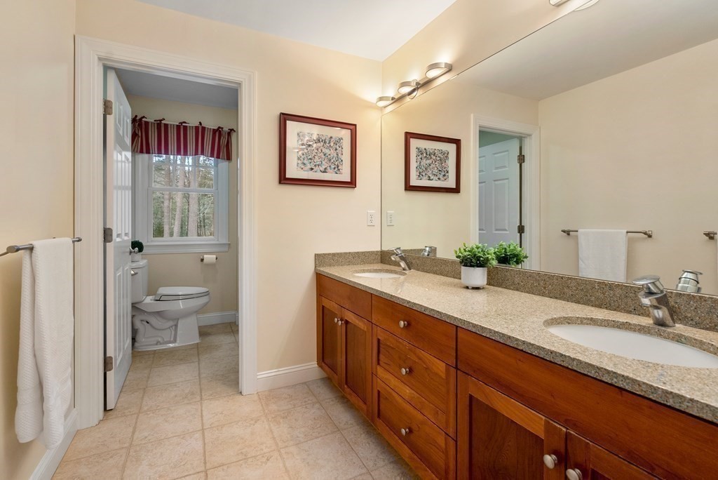 353 Dutton Road Sudbury, MA 01776 - Photo 29 of 42 a spacious bathroom with a granite countertop sink mirror and toilet