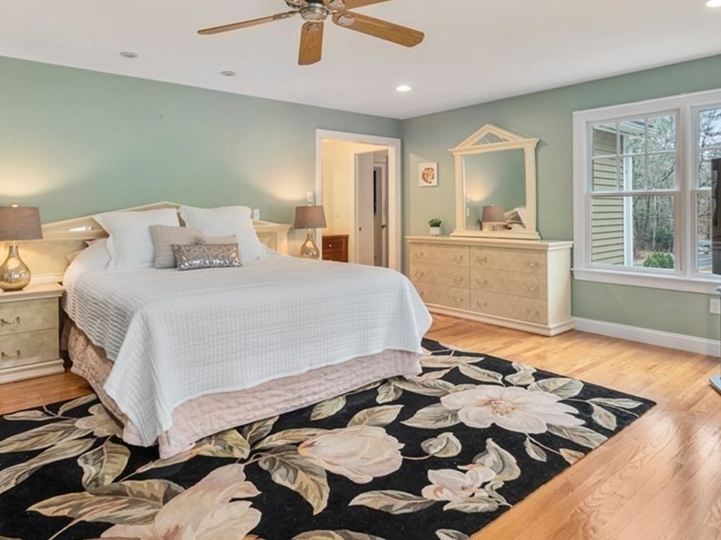 353 Dutton Road Sudbury, MA 01776 - Photo 31 of 42 a bedroom with a bed and wooden floor