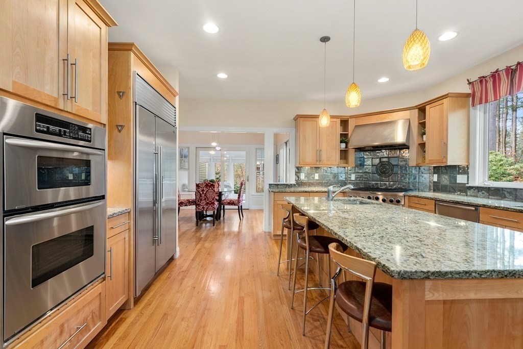 353 Dutton Road Sudbury, MA 01776 - Photo 10 of 42 a kitchen with stainless steel appliances granite countertop a stove and cabinets