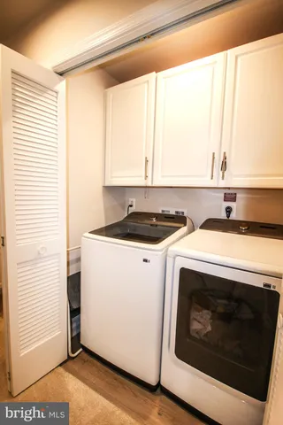 a view of washer and dryer with wooden floor
