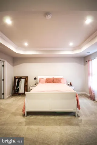 a spacious bedroom with a bed and a large mirror