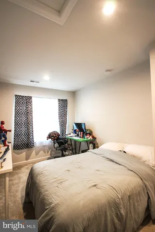 a bedroom with a bed and a large window