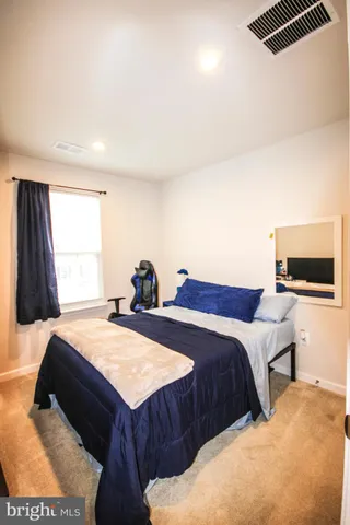 a bedroom with two beds and a window