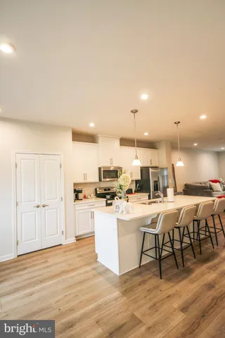 a large white kitchen with lots of counter space and furniture