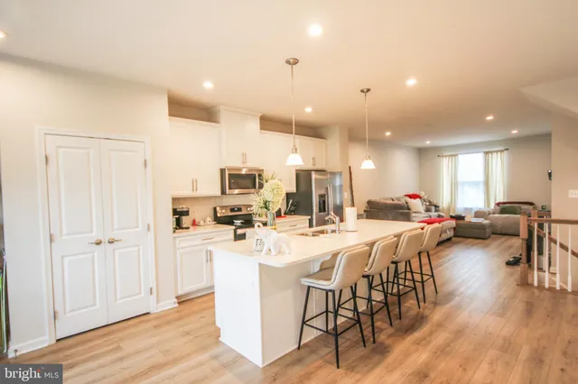 a large kitchen with a table and chairs