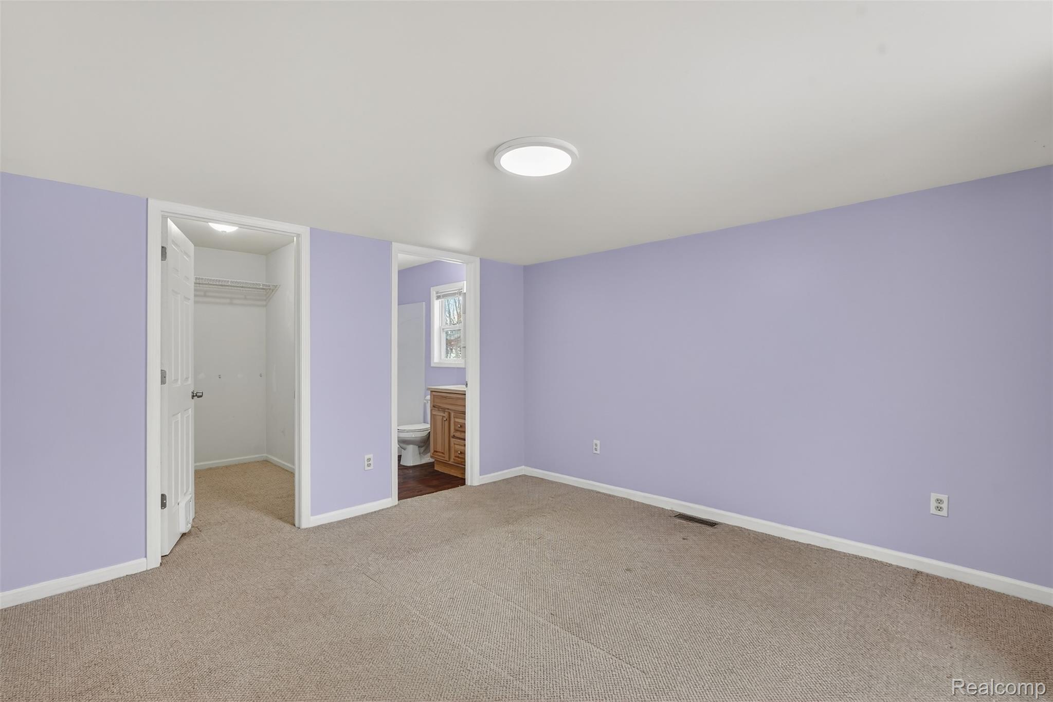 5417 Rensselear Drive Lapeer, MI 48446 - Photo 16 of 41 Unfurnished bedroom featuring a walk in closet, ensuite bath, and carpet floors