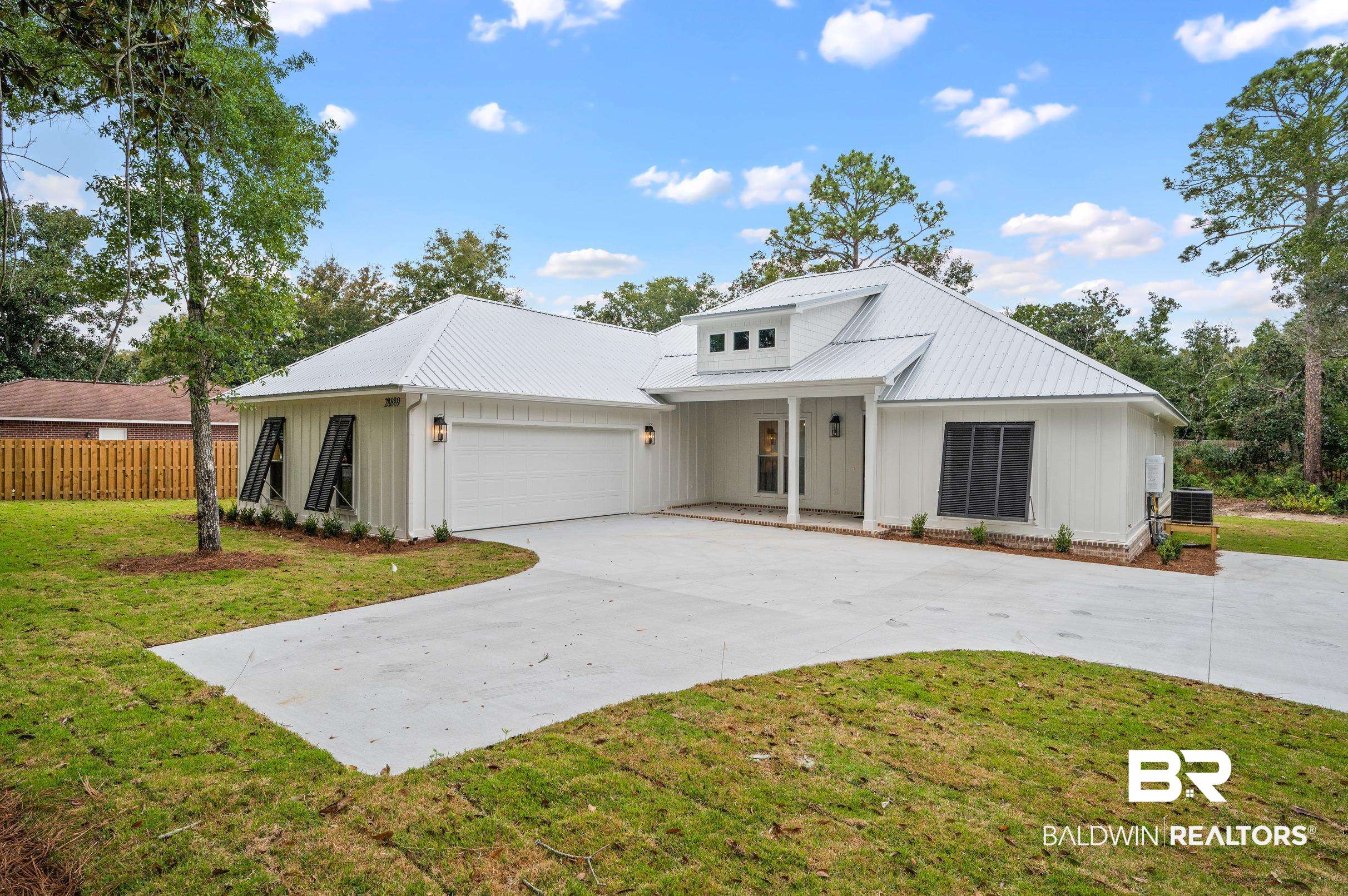 28889 Canal Road Orange Beach, AL 36561 - Photo 3 of 55 Modern farmhouse style home featuring central AC unit, a garage, and a front lawn