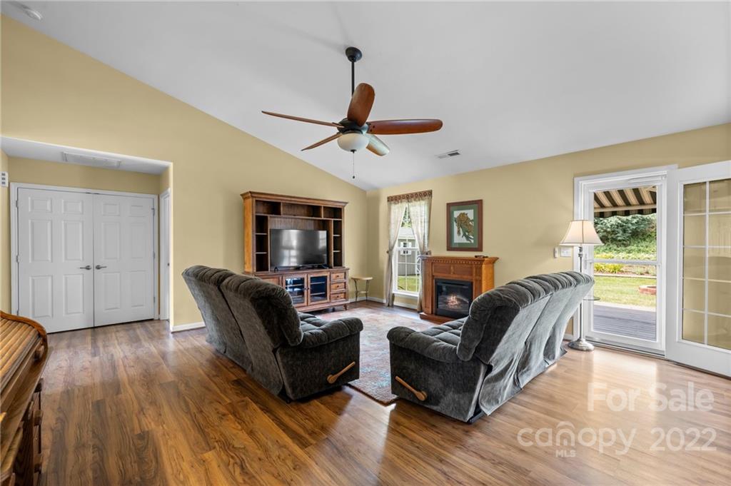 198 Lumber River Road Fletcher, NC 28732 - Photo 11 of 39 a living room with furniture a ceiling fan a fireplace and a window