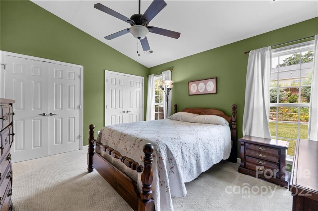 198 Lumber River Road Fletcher, NC 28732 - Photo 18 of 39 a bedroom with a bed and a chandelier