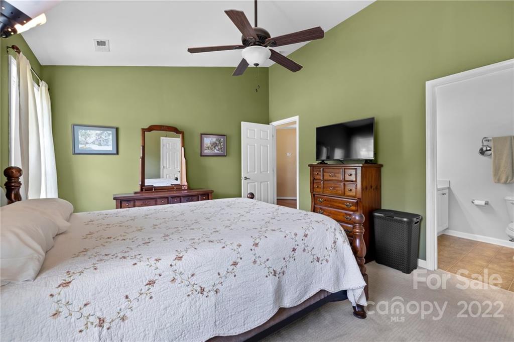 198 Lumber River Road Fletcher, NC 28732 - Photo 19 of 39 a bedroom with a bed and a flat screen tv