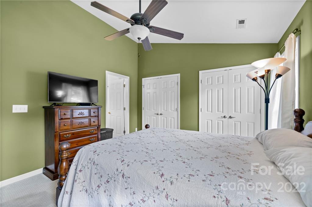 198 Lumber River Road Fletcher, NC 28732 - Photo 22 of 39 a bedroom with a bed and a flat tv screen on dresser