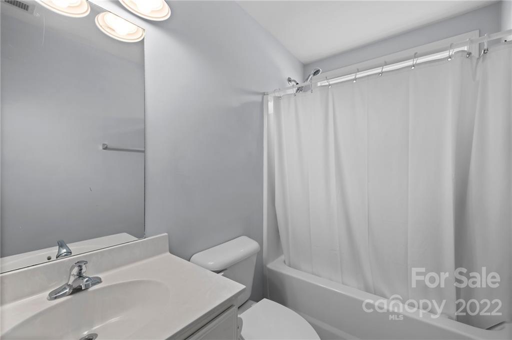 198 Lumber River Road Fletcher, NC 28732 - Photo 25 of 39 a bathroom with a sink and a mirror