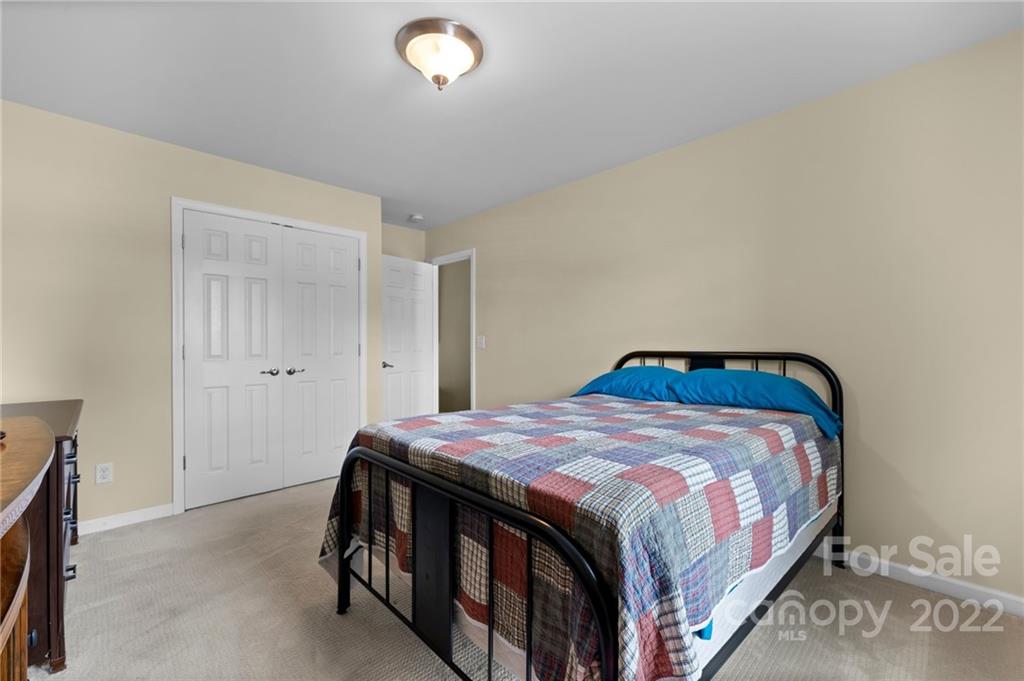 198 Lumber River Road Fletcher, NC 28732 - Photo 27 of 39 a bedroom with a bed and a cabinets