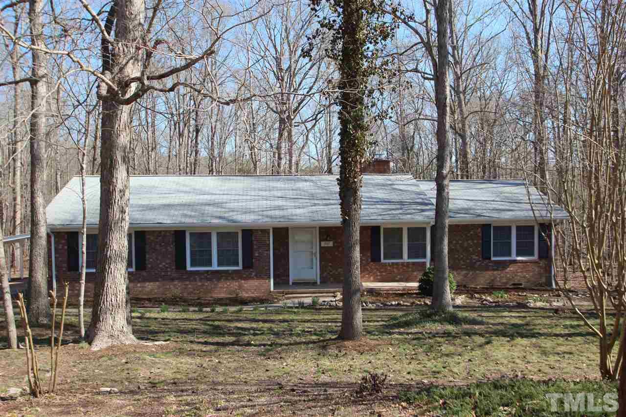a large tree in front of a house