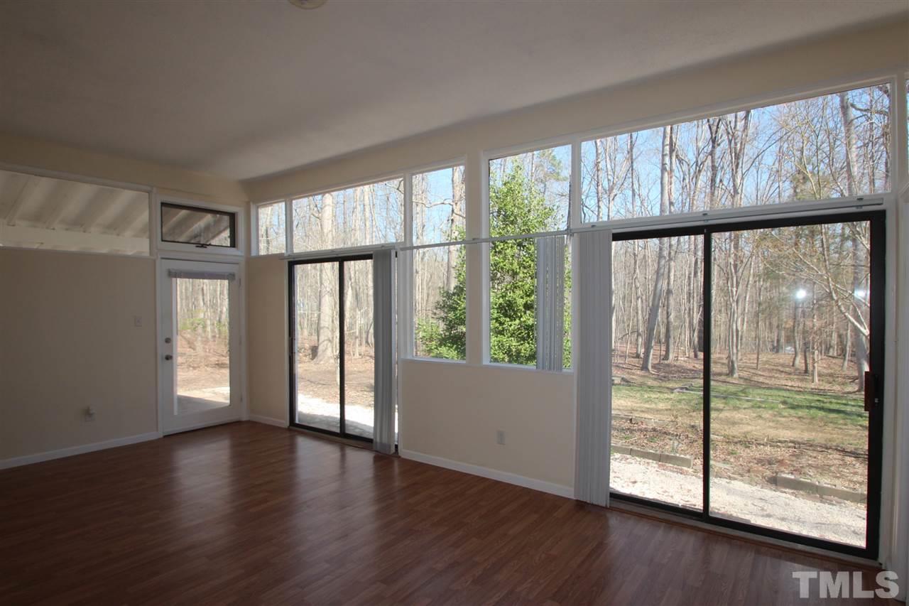 907 Torredge Road Durham, NC 27712 - Photo 15 of 19 a view of an empty room with wooden floor and a large window