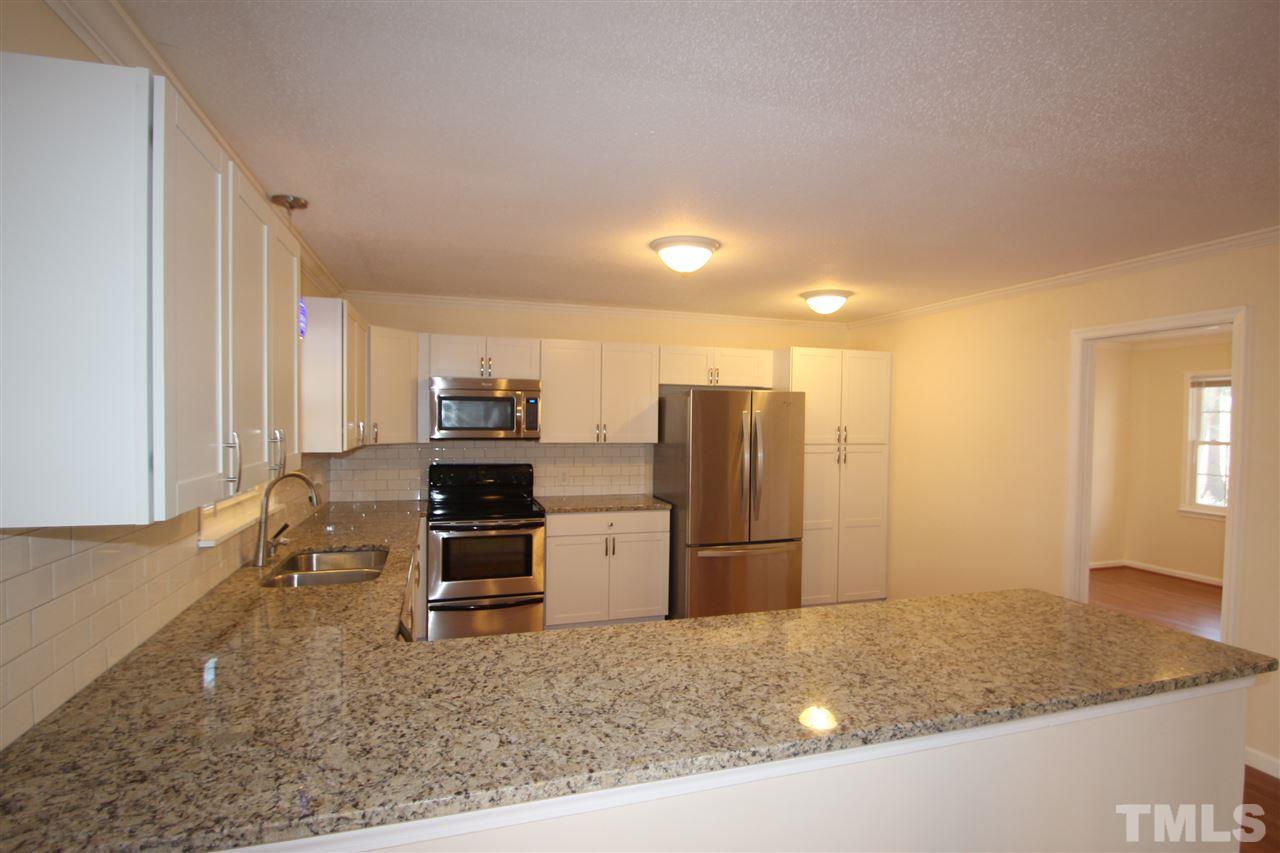 907 Torredge Road Durham, NC 27712 - Photo 3 of 19 a kitchen with refrigerator and stove