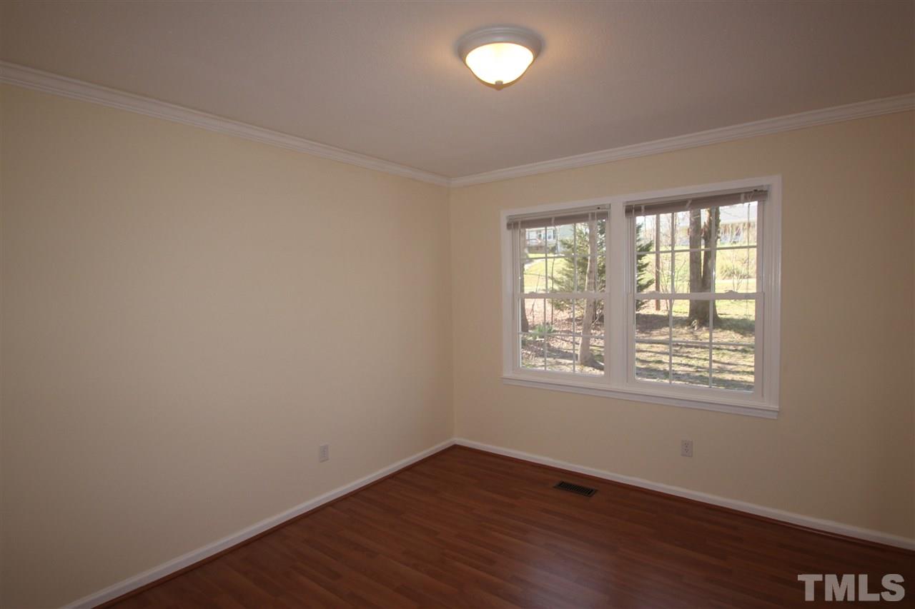 907 Torredge Road Durham, NC 27712 - Photo 6 of 19 an empty room with wooden floor and windows