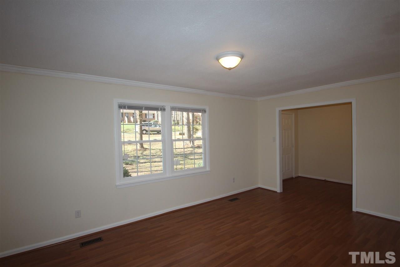 907 Torredge Road Durham, NC 27712 - Photo 7 of 19 a view of an empty room with wooden floor and a window