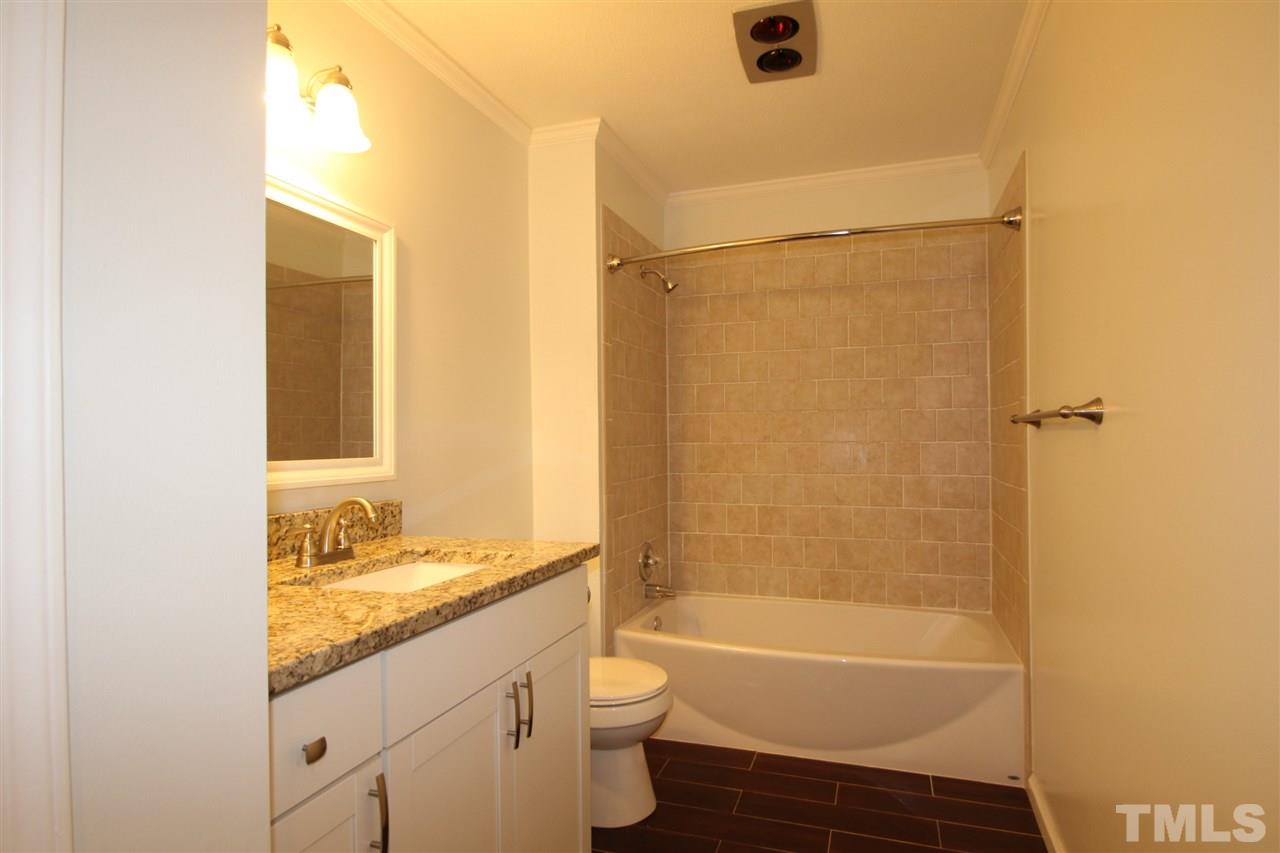907 Torredge Road Durham, NC 27712 - Photo 9 of 19 a bathroom with a granite countertop sink toilet and shower