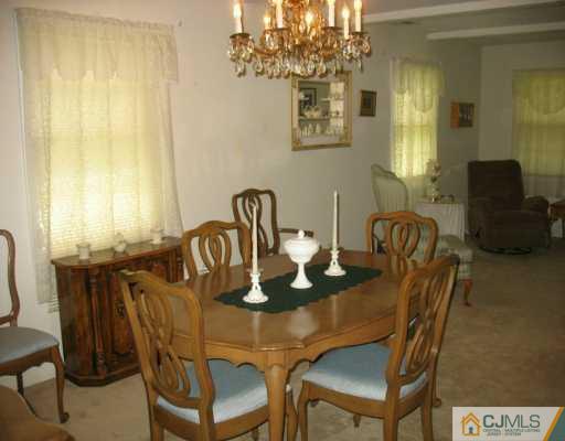 13 Sweetbriar Road Somerset, NJ 08873 - Photo 7 of 8 a view of a dining room with furniture and chandelier