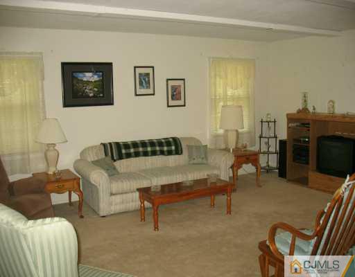 13 Sweetbriar Road Somerset, NJ 08873 - Photo 8 of 8 a living room with furniture and a fireplace