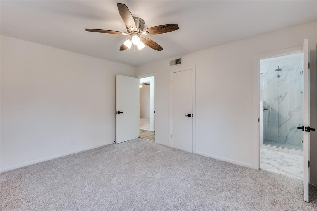 624 Forest Lane Hurst, TX 76053 - Photo 20 of 25 Unfurnished bedroom with carpet, ceiling fan, and ensuite bath