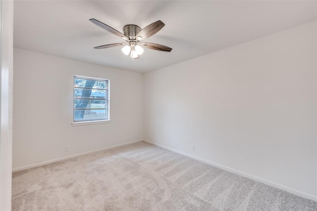 624 Forest Lane Hurst, TX 76053 - Photo 22 of 25 Unfurnished room with carpet and a ceiling fan