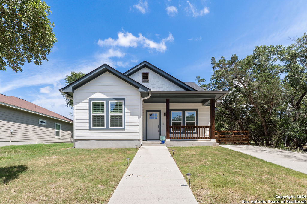 1125 Cedar Grove Trail Spring Branch, TX 78070 - Photo 2 of 23 a front view of a house with a garden