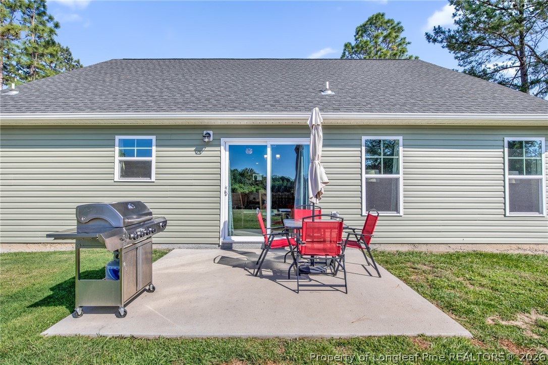 351 Sandy Grove Road Parkton, NC 28371 - Photo 24 of 30 a view of house with a bench and chairs